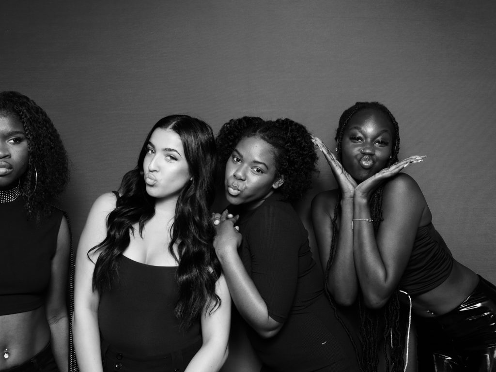 Women posing for a glam photo booth in black and white.