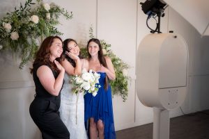 A bride and her bridesmaids pose for a photo at a wedding.